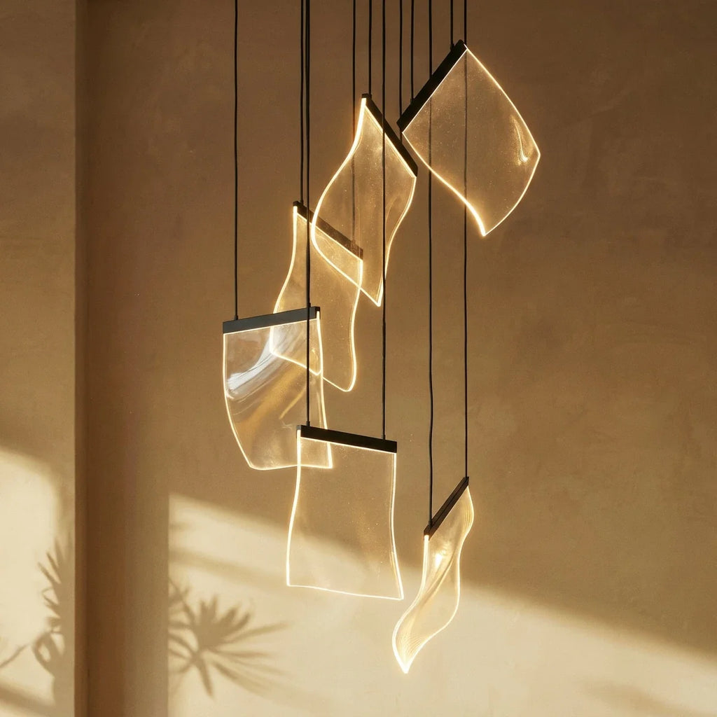 Clérachic chandelier's acrylic sheet panes glowing warm against a sunlit plaster wall, cords catching the light.