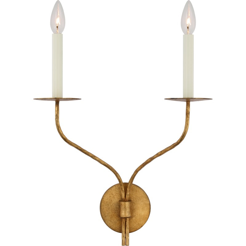 Clérachic's Eris wall lamp shown in its two-arm brass version, both candle covers glowing warm on white.