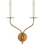 The Clérachic Eris wall lamp's two-arm brass version unlit, cream candle covers topping both arms.