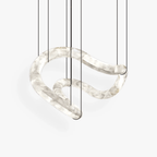 Clérachic Ethereal chandelier on white, one continuous alabaster ribbon looping on slim cables.