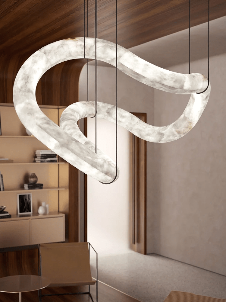 Clérachic Ethereal chandelier at an angle beneath wood panelling, its curve catching the light.