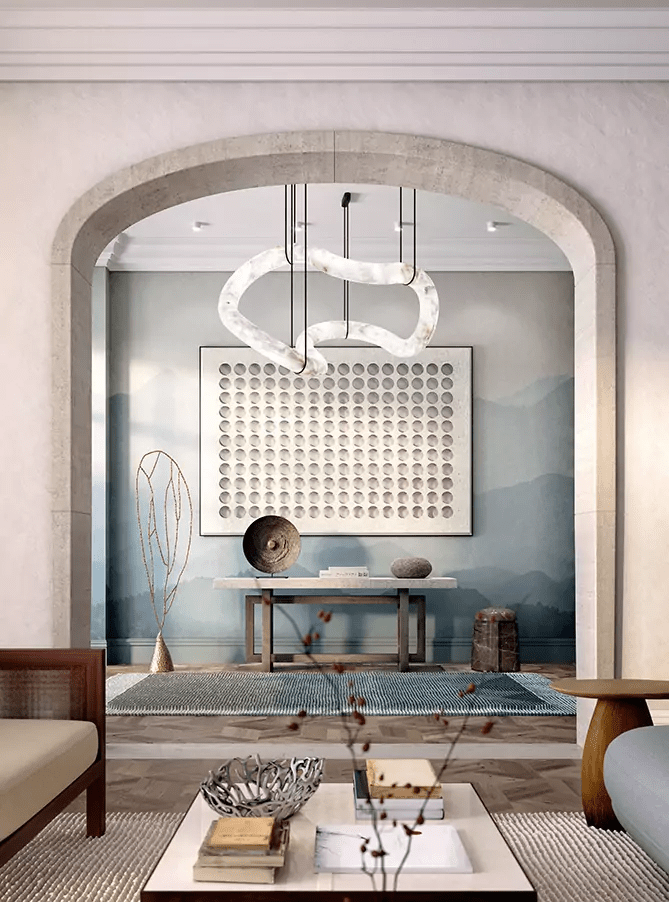 Clérachic Ethereal chandelier hung in an arched alcove above a console table and blue artwork.