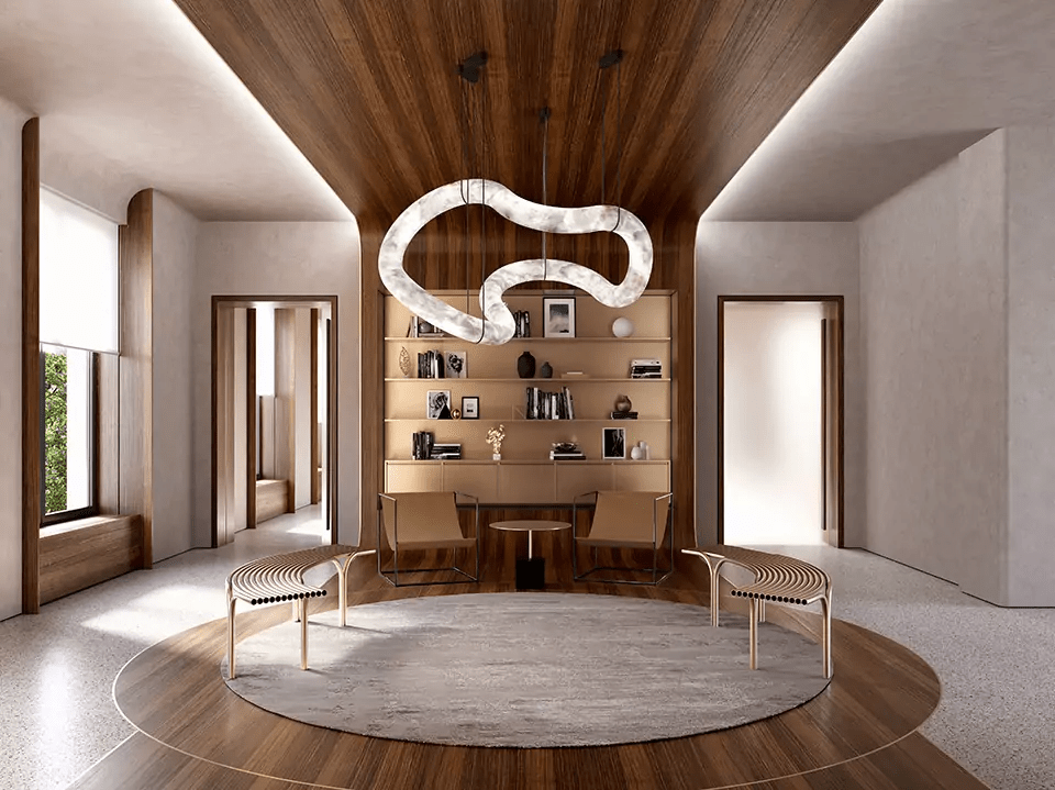 The Clérachic Ethereal chandelier over a symmetrical lounge with a circular rug and low chairs.