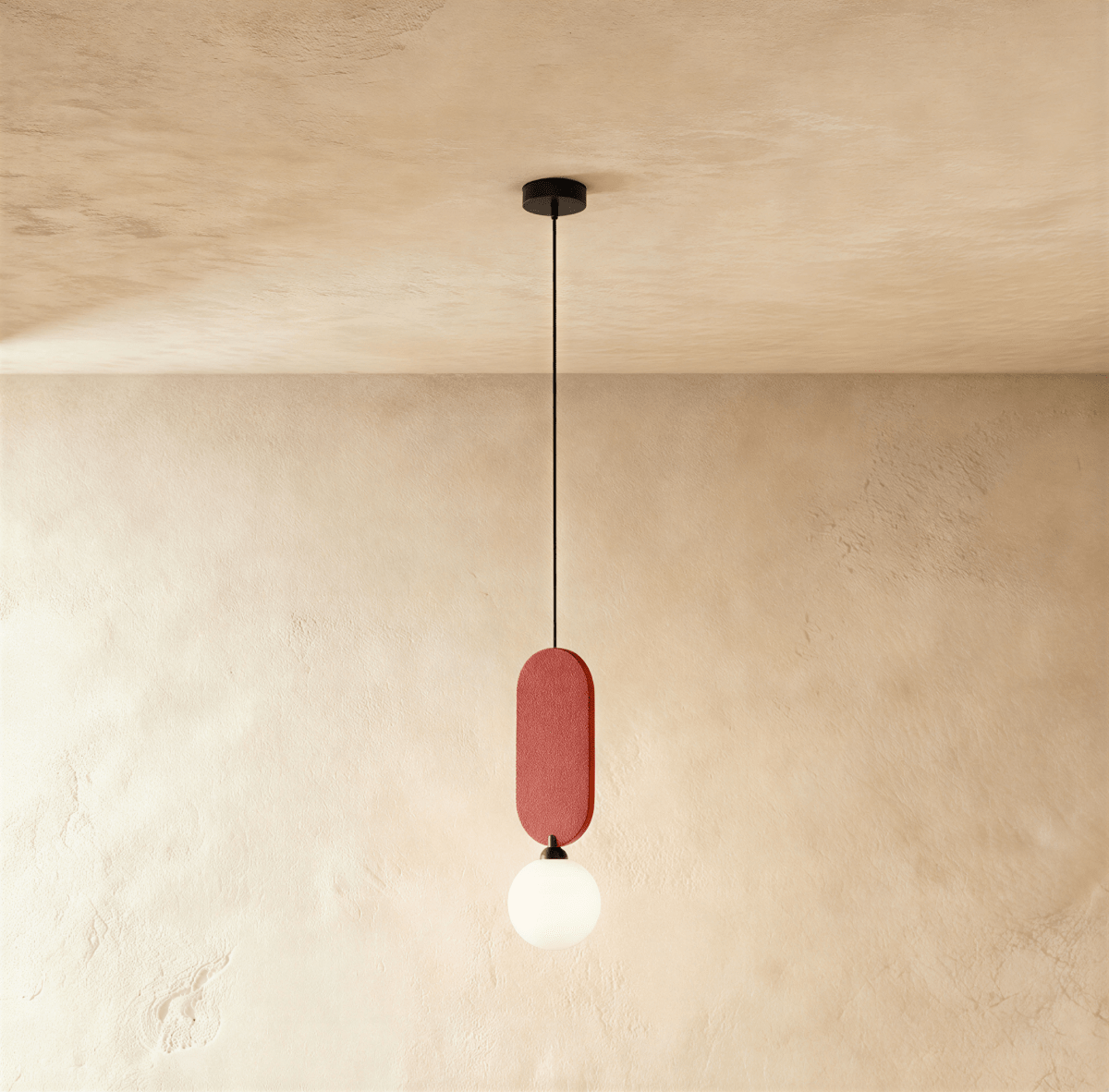 Clérachic single pendant with a brick red fabric pill panel above a milk white glass globe, hung against plaster.