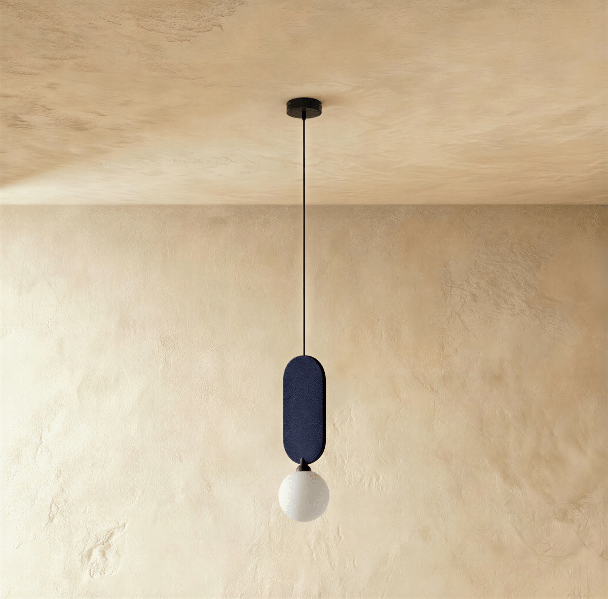 Clérachic single pendant with a navy fabric pill panel and a matte milk white glass globe on a black cord and canopy.