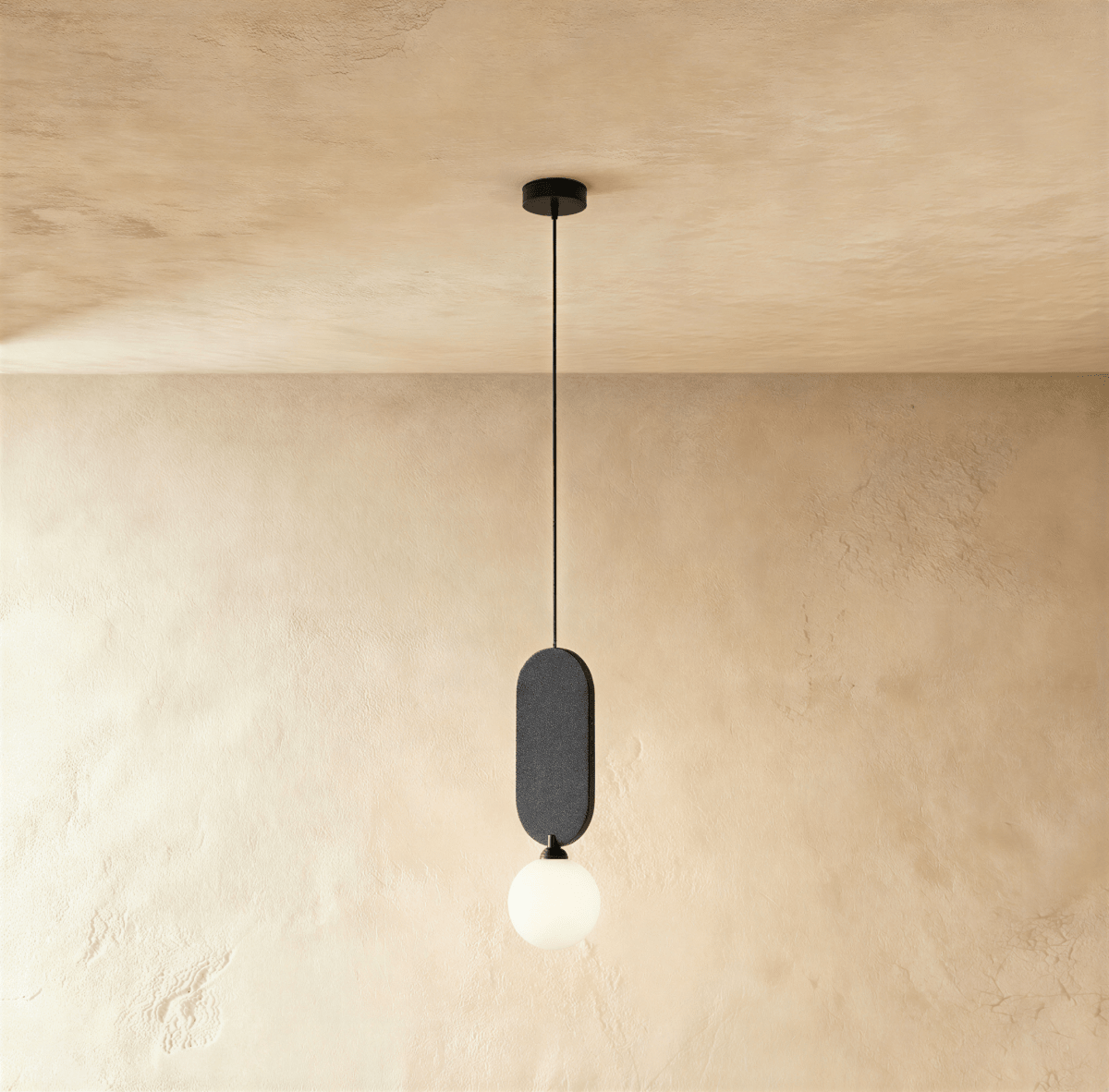 Clérachic single pendant with a charcoal grey fabric pill panel over a milk white glass globe on a black cord.