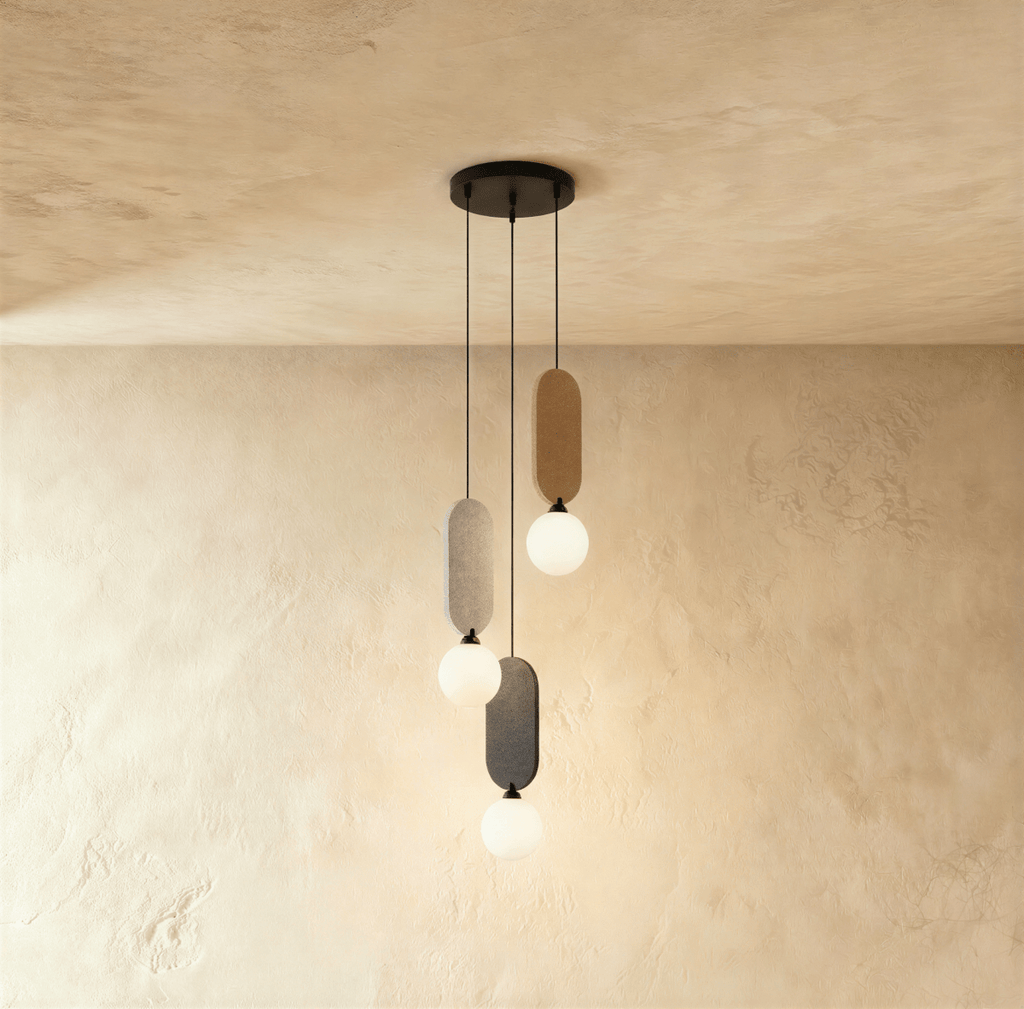 Clérachic three-head pendant on a round black canopy, with beige, light grey and charcoal fabric panels and white globes.