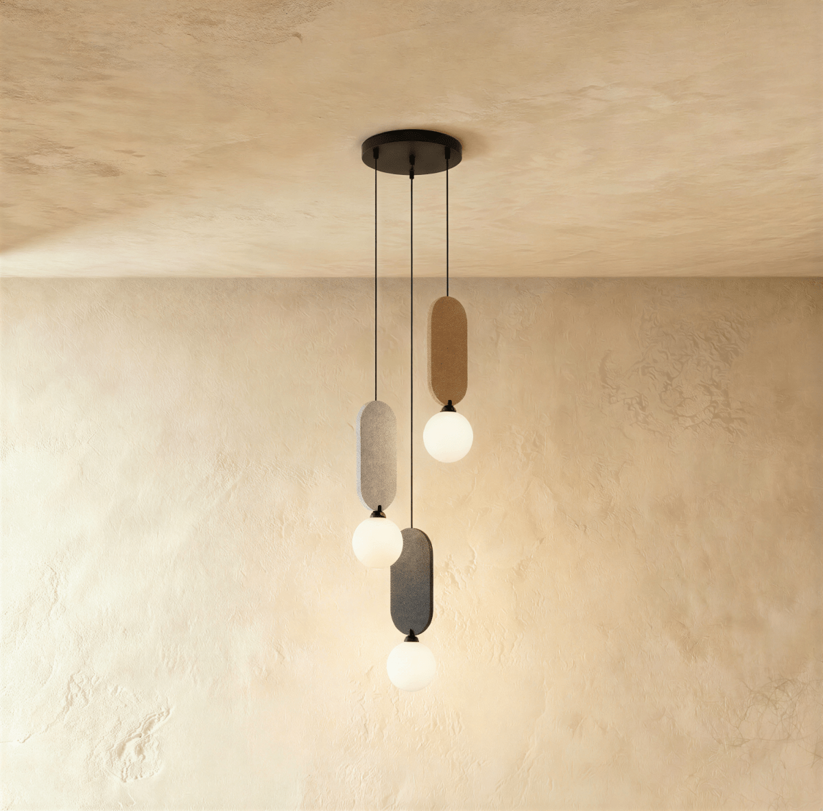 Clérachic three-head pendant on a round black canopy, with beige, light grey and charcoal fabric panels and white globes.