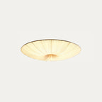 Clérachic pleated ceiling light on a pale grey backdrop, lit, shown from a lower angle with gathered folds at the centre.
