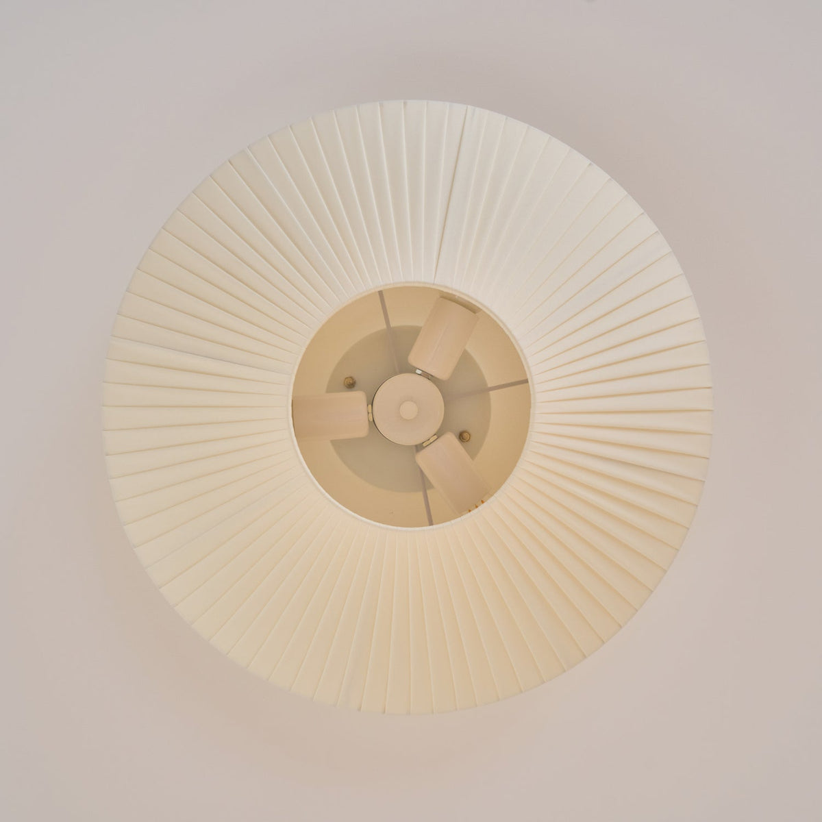 View from directly below at the pleats of this Clérachic ceiling light and the inner fitting around the diffuser.