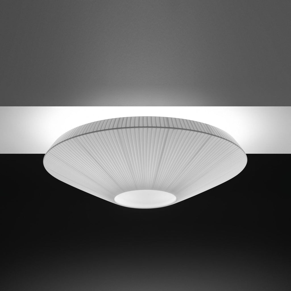 Grey-toned Clérachic pleated ceiling light with a pale opal diffuser, lit against a dark ceiling.
