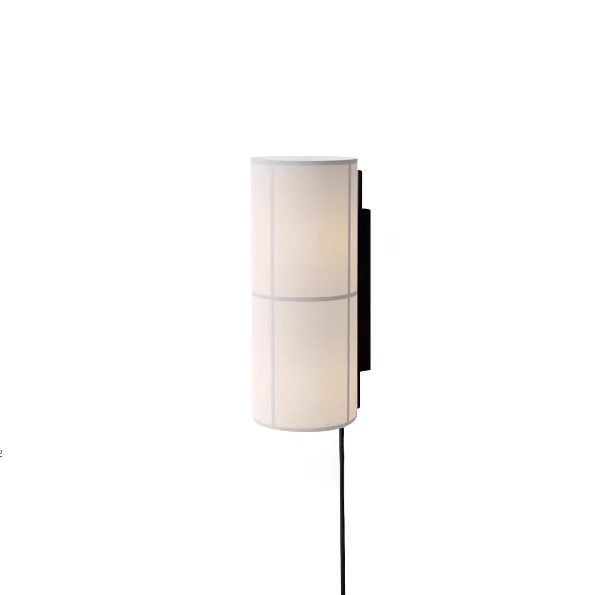 A white Clérachic cylinder wall light, softly lit, on a white backdrop with a black cord hanging below it.