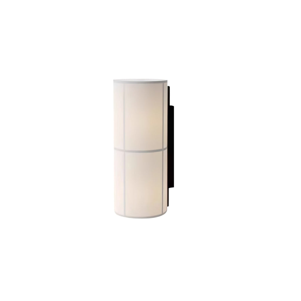 Short version of the Clérachic cylinder wall light in white, lit, on a plain white backdrop with a black back plate.