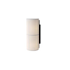 Short version of the Clérachic cylinder wall light in white, lit, on a plain white backdrop with a black back plate.