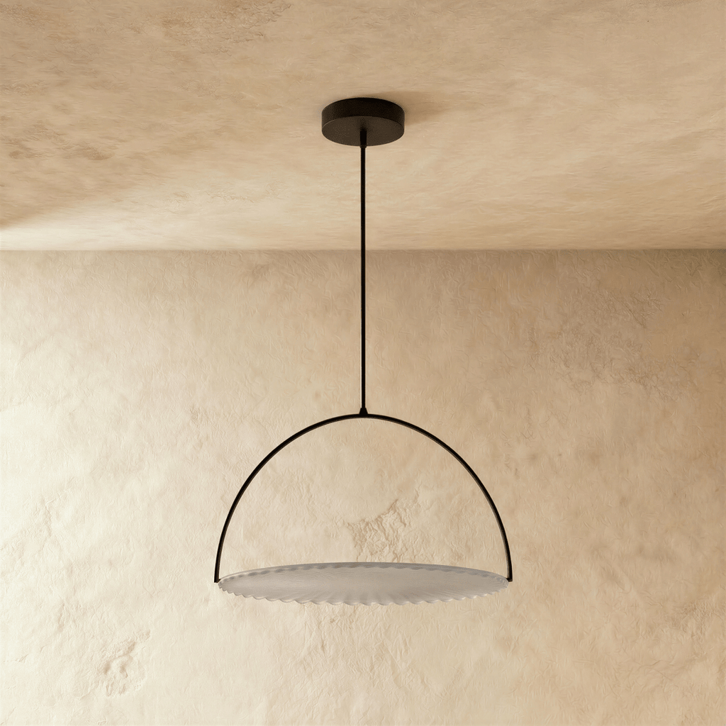 Clérachic black steel arch pendant with a pleated white fabric disc, switched off and hung on a rod from a plaster ceiling.