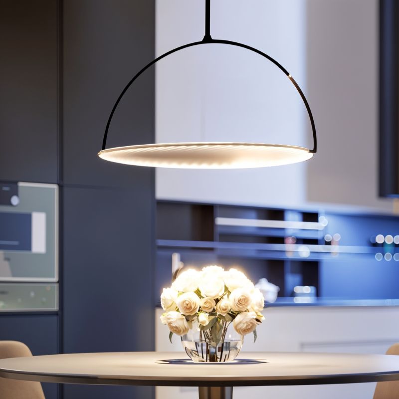 Clérachic black arch pendant with a glowing pleated disc hung above a round dining table with a bunch of cream roses.