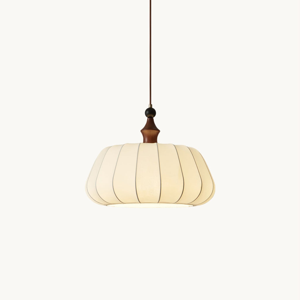 Pleated cream fabric dome pendant with a walnut-colour wood top and a black bead above, hung on a thin cord, from Clérachic on white.