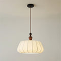 Full drop of this Clérachic pendant, from the black round canopy and brown cord to the wood top and the pleated cream fabric dome.