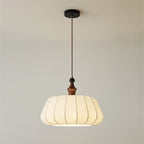 Full drop of this Clérachic pendant, from the black round canopy and brown cord to the wood top and the pleated cream fabric dome.