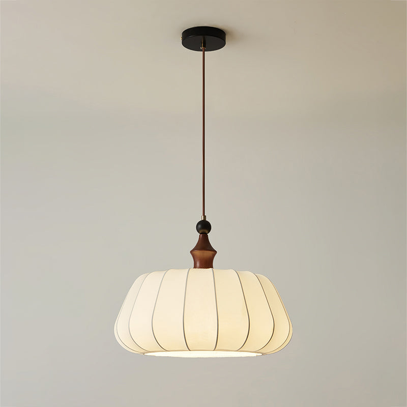 Full drop of this Clérachic pendant, from the black round canopy and brown cord to the wood top and the pleated cream fabric dome.