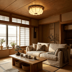 A Clérachic fabric ceiling light glows under a timber-clad ceiling, above a linen sofa and low table, beside sliding paper screens.