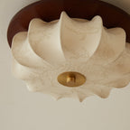 Close view of the etched floral pattern on the fabric shade of this Clérachic ceiling light, with its brass centre cap.