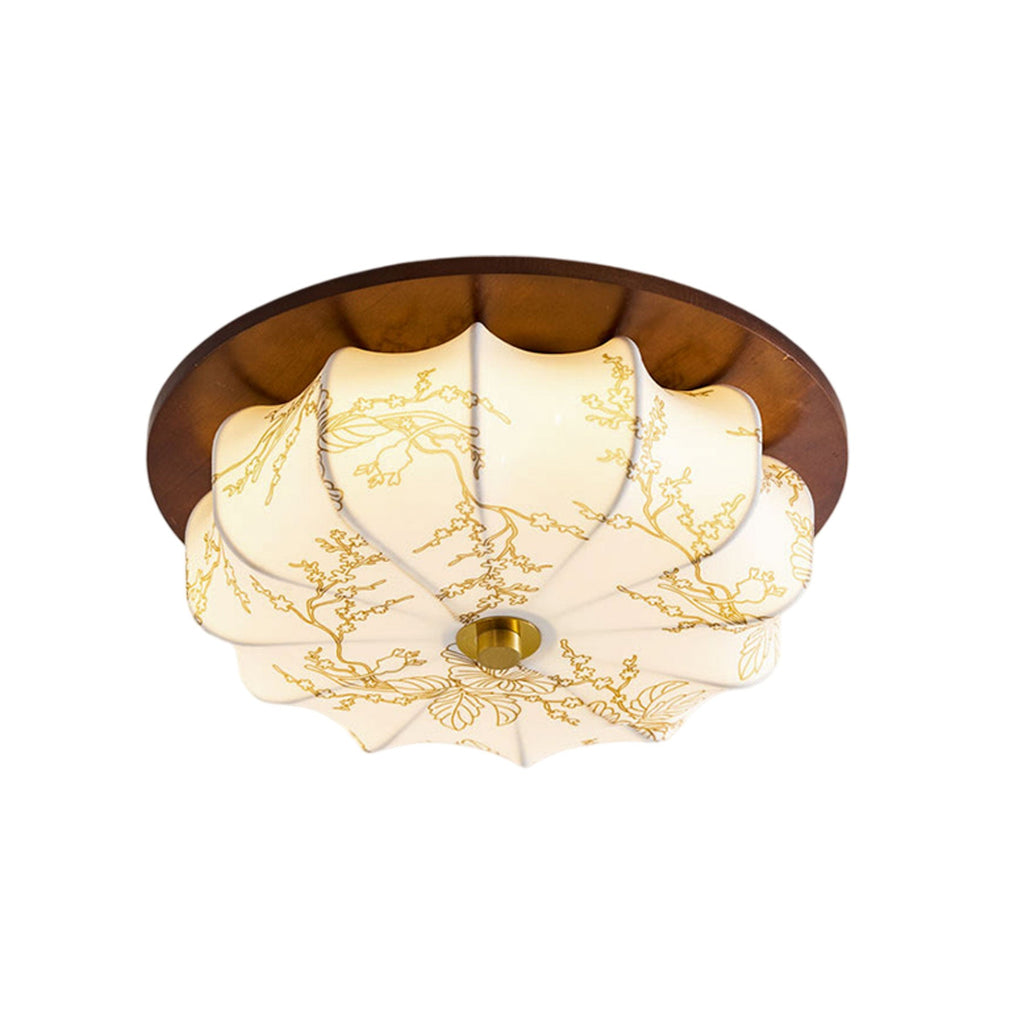 A Clérachic ceiling light with a walnut rim, a pleated floral-etched shade and a brass centre cap, on a plain white backdrop.