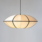 A wide fabric pendant with a pointed rim and black ribs hangs on a black cord against a plain grey backdrop, a Clérachic pendant.