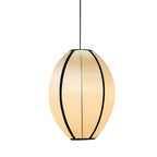 A tall egg-shaped fabric pendant with black ribs hangs against a white backdrop, lit warm, from Clérachic.