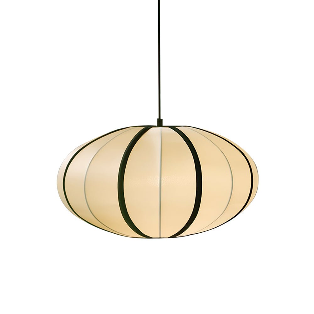 A flattened fabric pendant with black ribs and a warm glow hangs on a black cord against a white backdrop, from Clérachic.