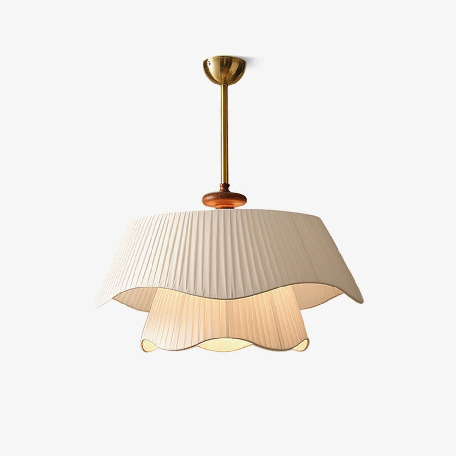 A Clérachic pendant on a plain white backdrop, with a pleated double-layer wavy fabric shade, a wooden bead and a gold stem.