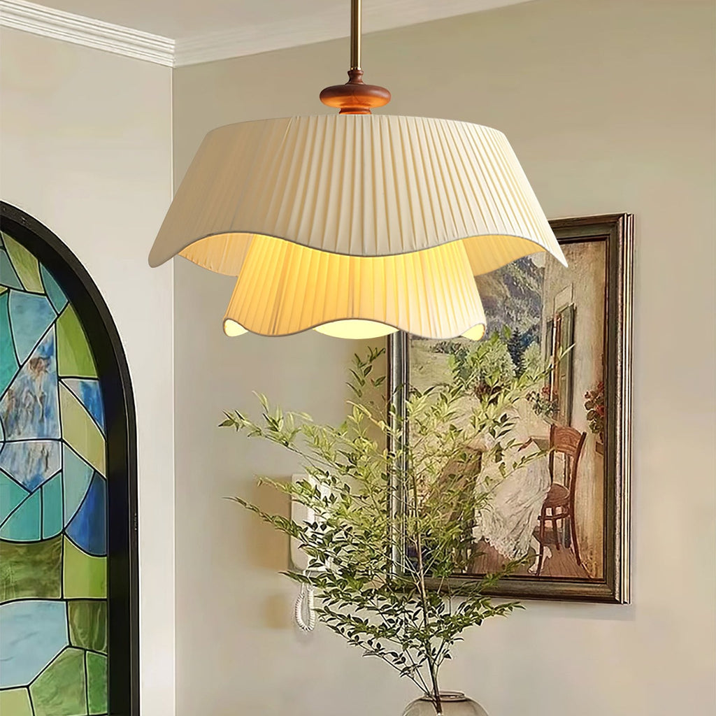 Warm light spills from the lower layer of this Clérachic pendant, set in a hallway with a stained-glass arch and a framed painting.