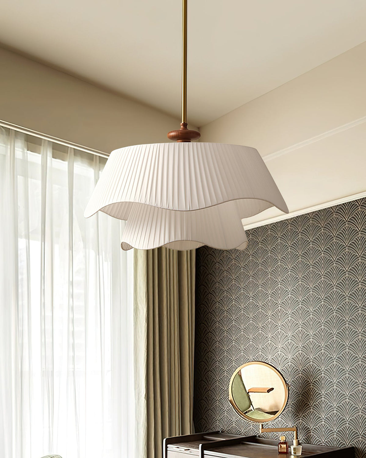 Angled view of the Clérachic pendant beside a window with sheer curtains, a patterned grey wall and a round mirror.