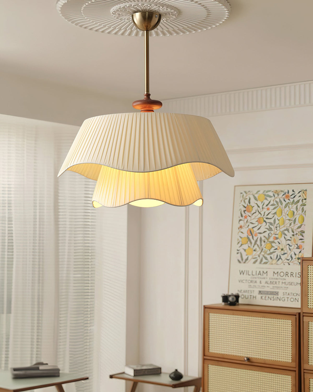 Looking up at this Clérachic pendant on a gold stem, hung from a ceiling rose with the lower fabric layer glowing.