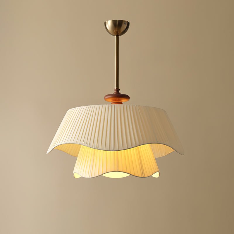 Close, brighter view of this Clérachic pendant with a warm golden glow under the upper shade and in the inner layer.