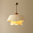 Close, brighter view of this Clérachic pendant with a warm golden glow under the upper shade and in the inner layer.