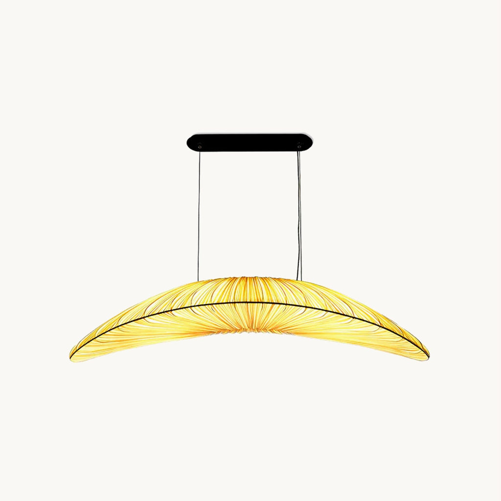 This Clérachic pendant on a plain white backdrop, a long leaf-shaped fabric shade with pleats and a black oval ceiling plate above.