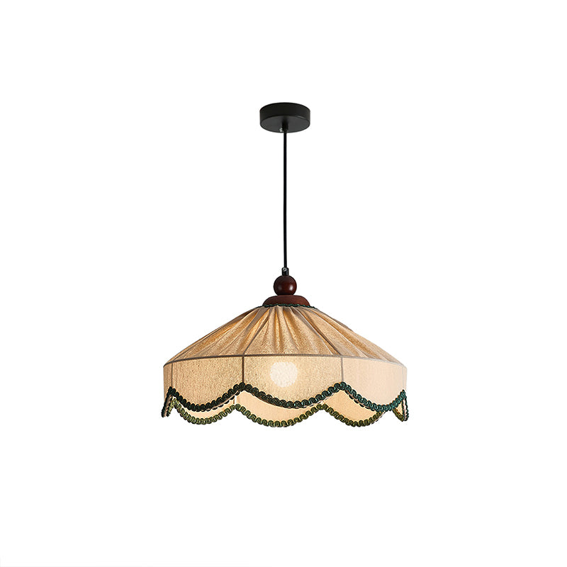 Clérachic pleated beige pendant with green trim and a black ceiling canopy, shown unlit on a white backdrop.