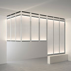 Many Clérachic fabric panels lit as a wall of tall strips, each framed by a dark bar at the top, in a white room.