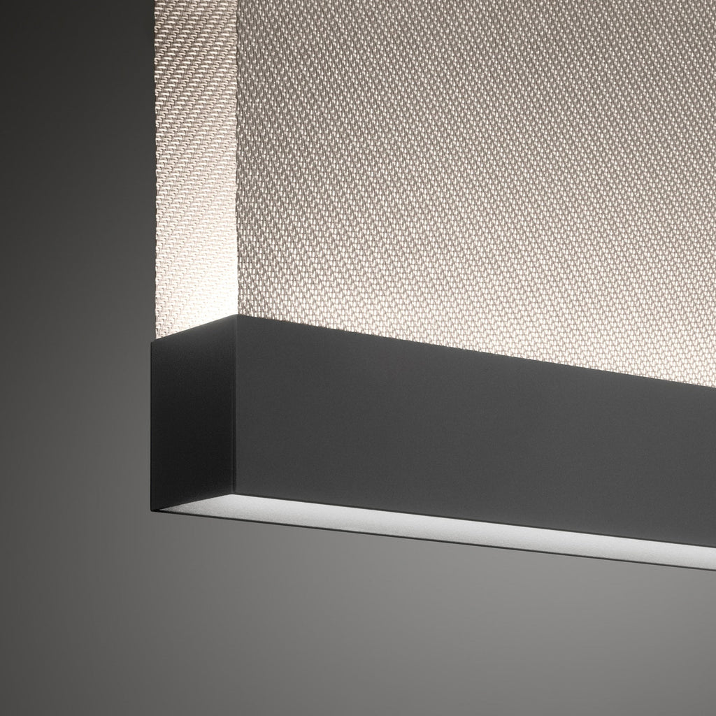 Close view of the black bottom bar on this Clérachic fabric pendant, with a diagonal woven fabric above it and a light line below.