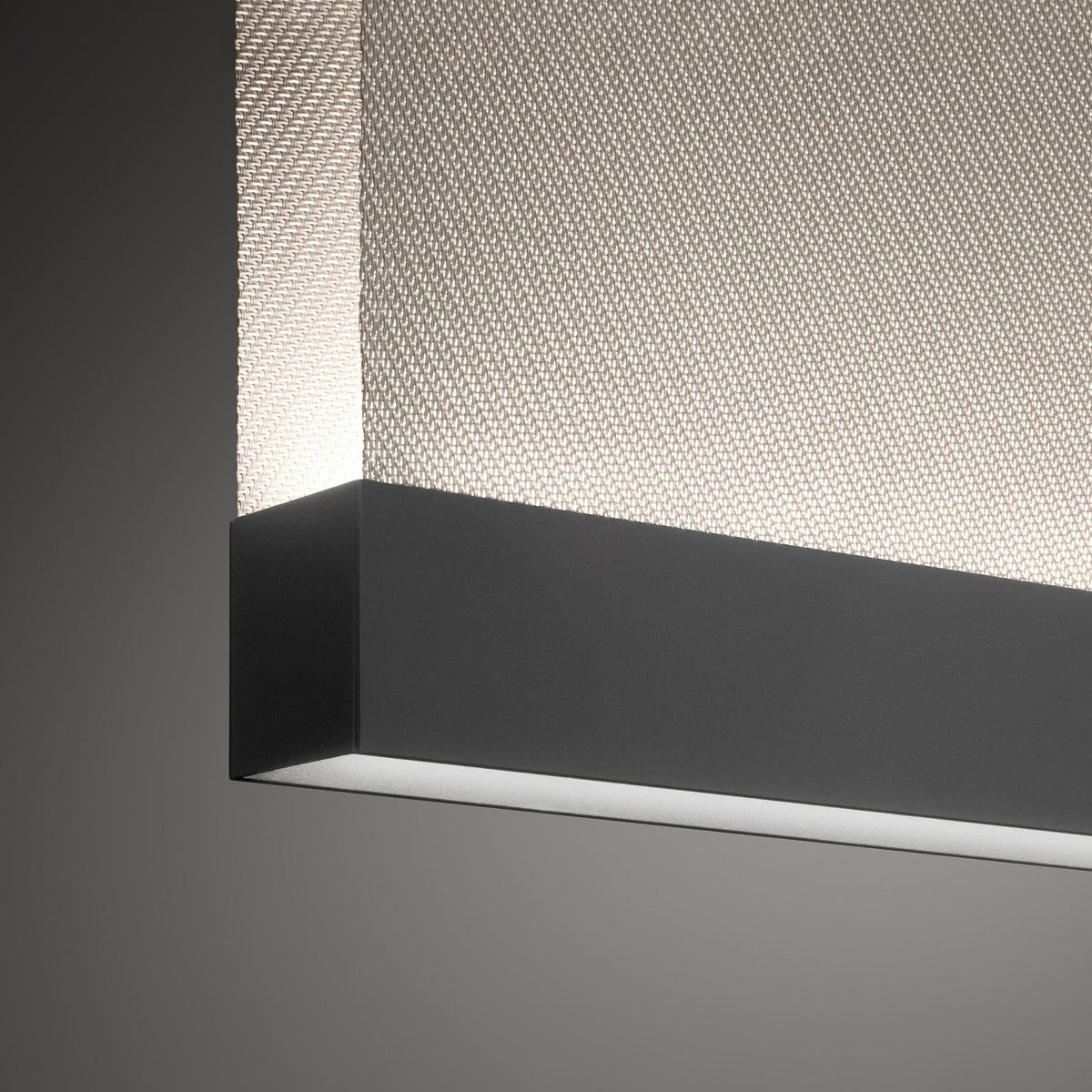 Close view of the black bottom bar on this Clérachic fabric pendant, with a diagonal woven fabric above it and a light line below.