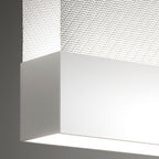 Close view of a white bottom bar on this Clérachic fabric pendant, with a fine woven fabric above it and a bright light line below.