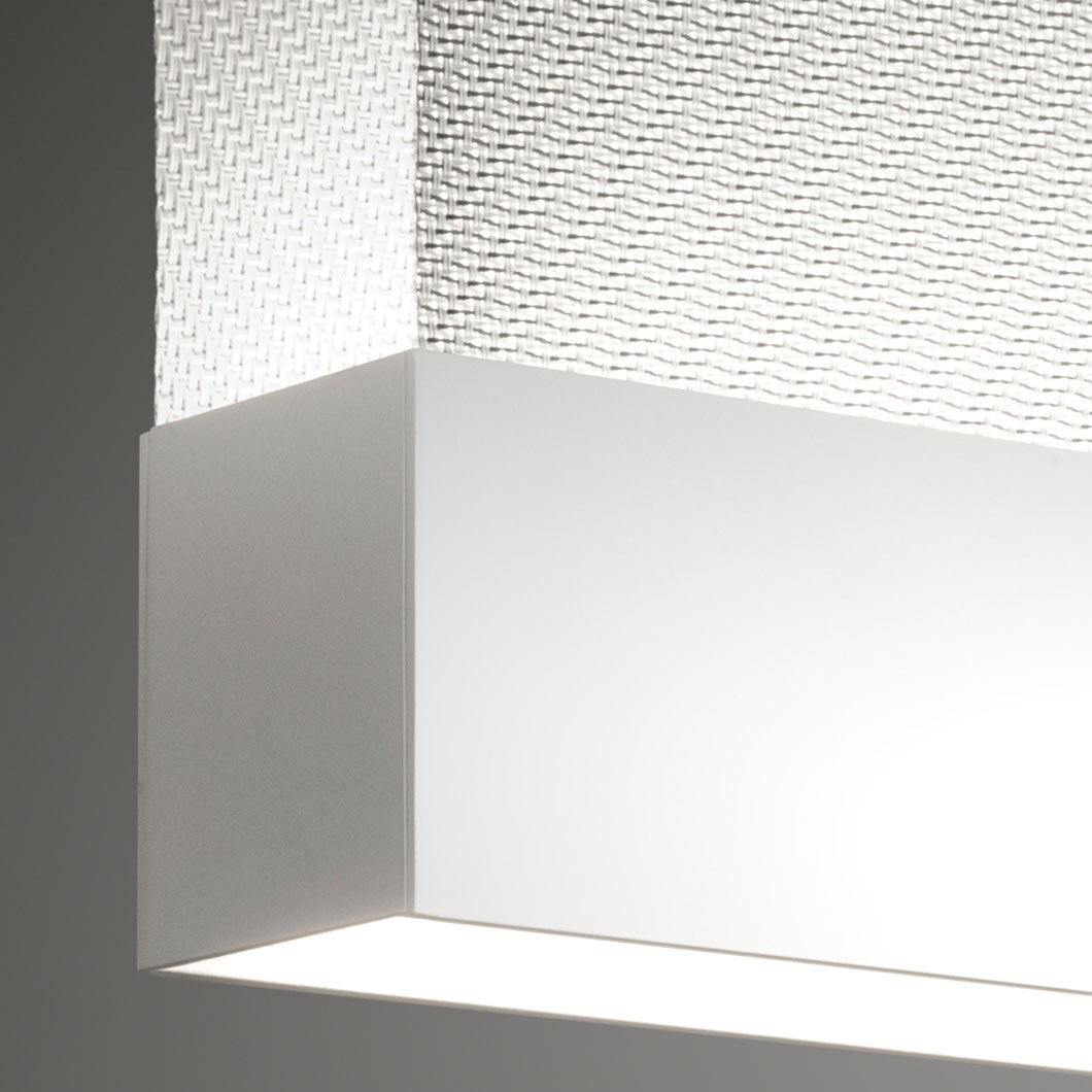 Close view of a white bottom bar on this Clérachic fabric pendant, with a fine woven fabric above it and a bright light line below.