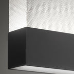 Close view of the black bottom bar and woven fabric on this Clérachic pendant, with a light line along the underside.