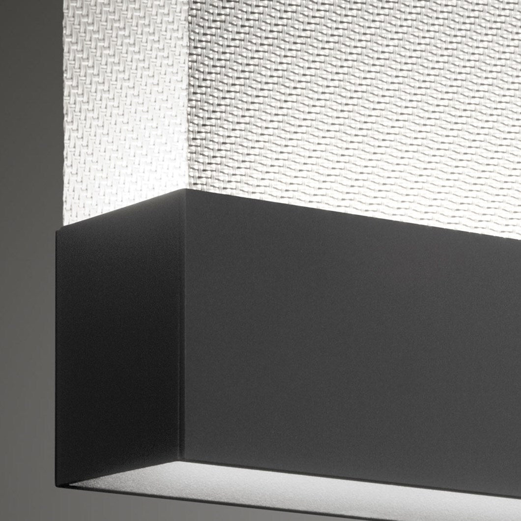Close view of the black bottom bar and woven fabric on this Clérachic pendant, with a light line along the underside.