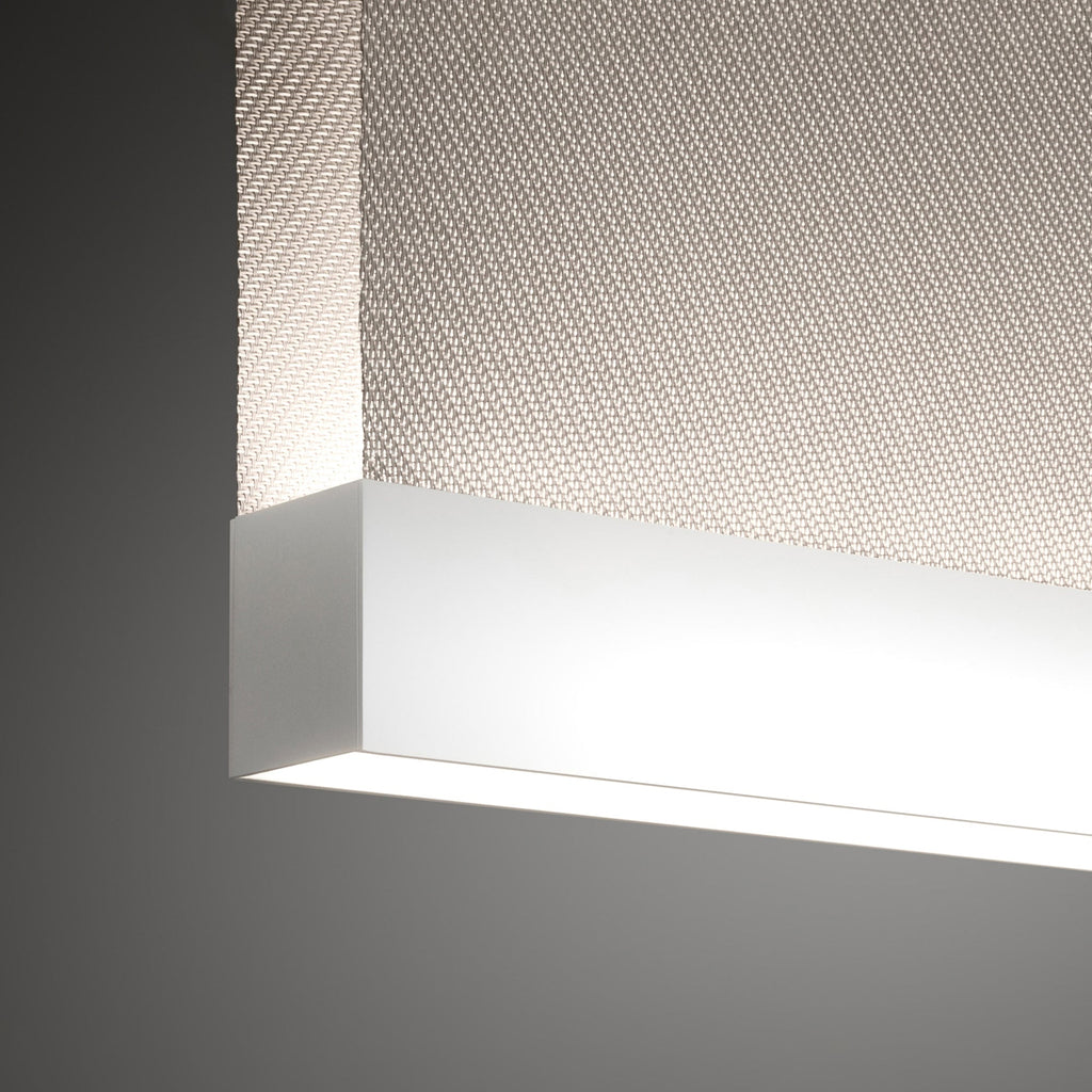 Close view of the white bottom bar on this Clérachic fabric pendant, where it meets the woven fabric, with bright light along the underside.