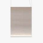 Large tall Clérachic fabric pendant with a white bottom bar and two thin wires, the taupe fabric fading to a pale lit base.