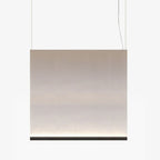 Broad Clérachic fabric pendant with a black bottom bar, hung on two wires, the taupe fabric fading to a lit base.