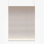 Large portrait Clérachic fabric pendant with a white bottom bar, on two thin wires, with the taupe fabric glowing at the base.