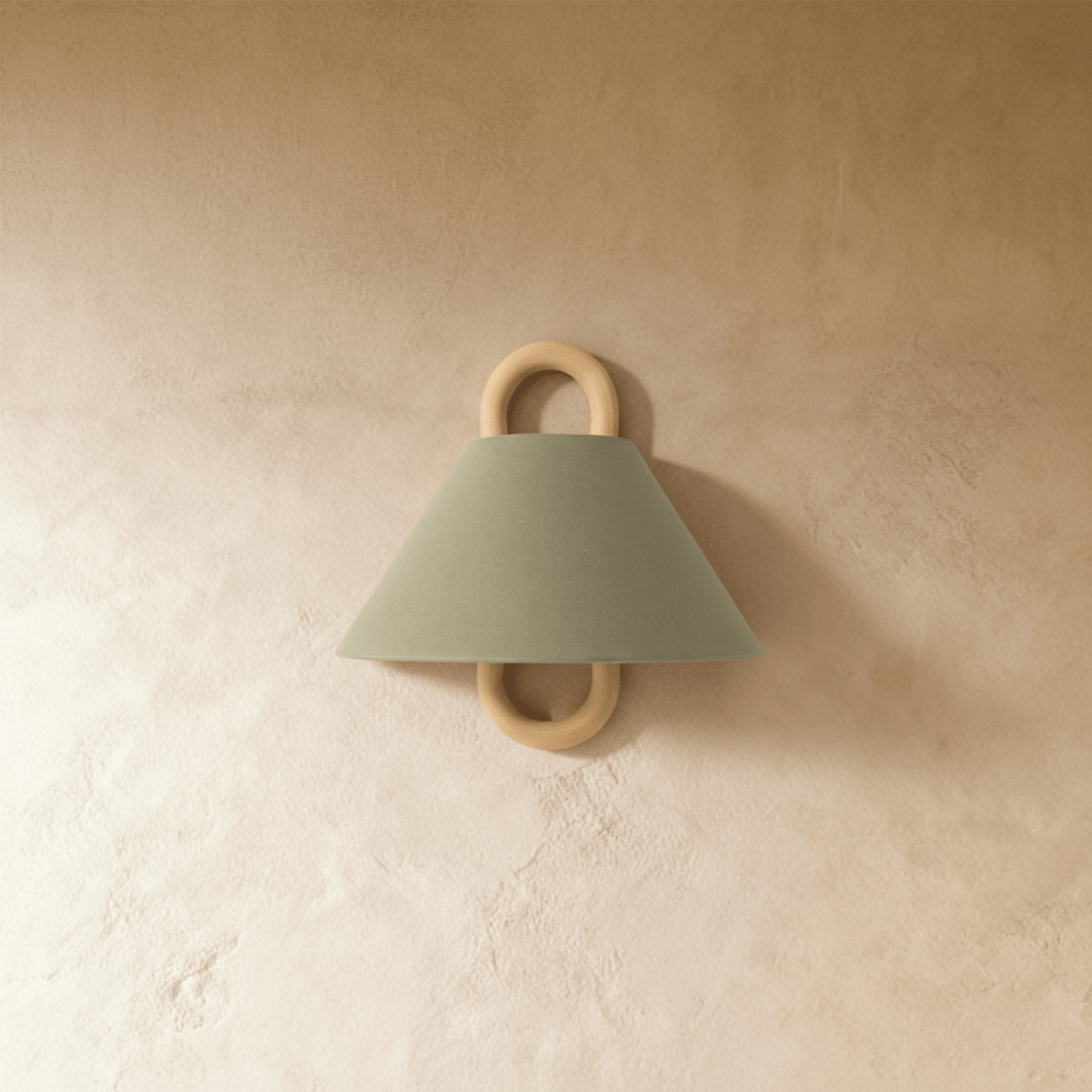 Clérachic wall sconce in sage green fabric with a wood ring bracket, shown unlit against a warm plaster wall.